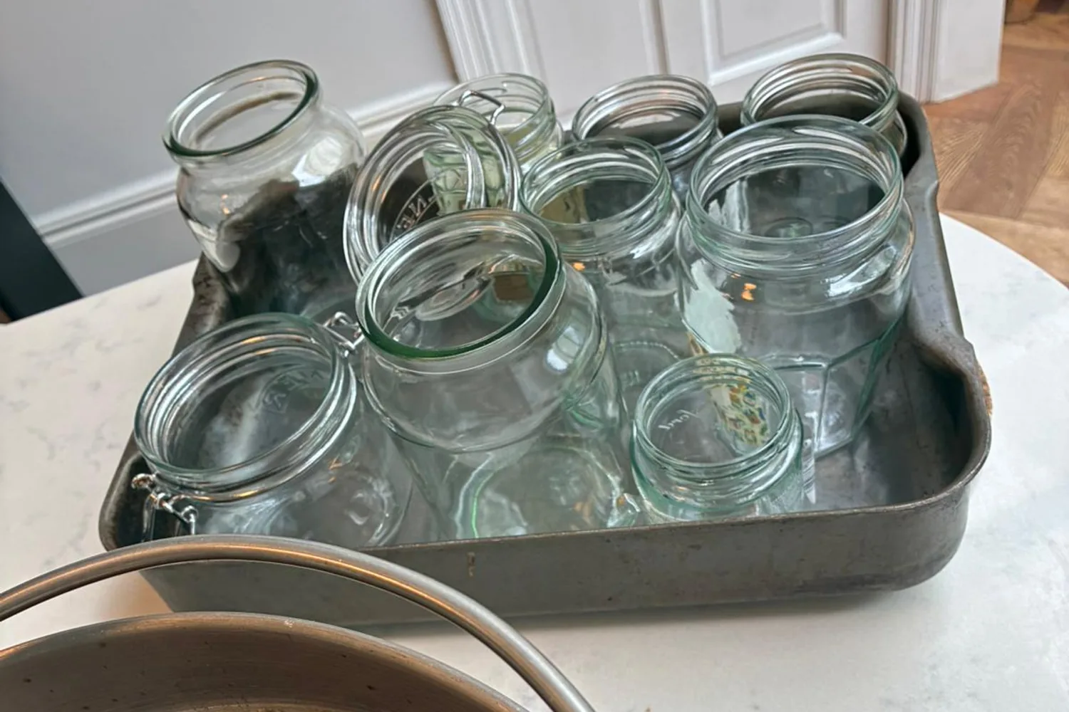 Clean glass jars standing ready beside the chutney pan