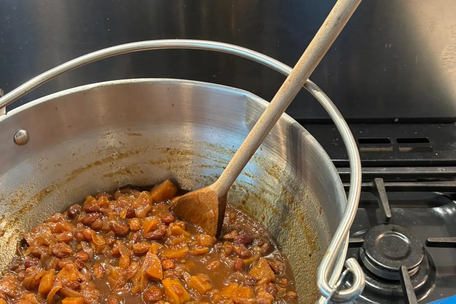 Apple and pear chutney simmering with onions and sultanas in a preserving pan